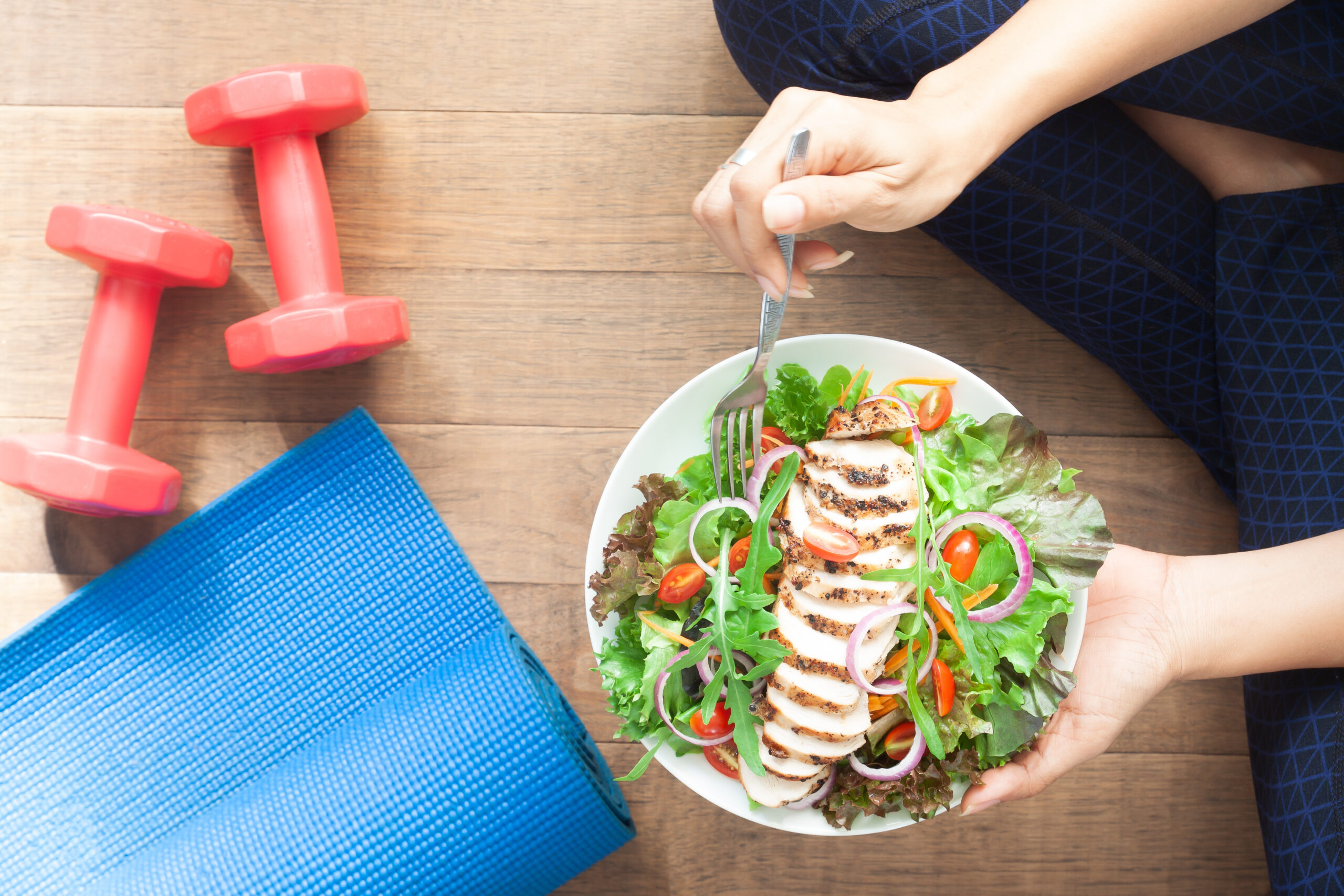 Girl eating a healthy chicken salad for functional health