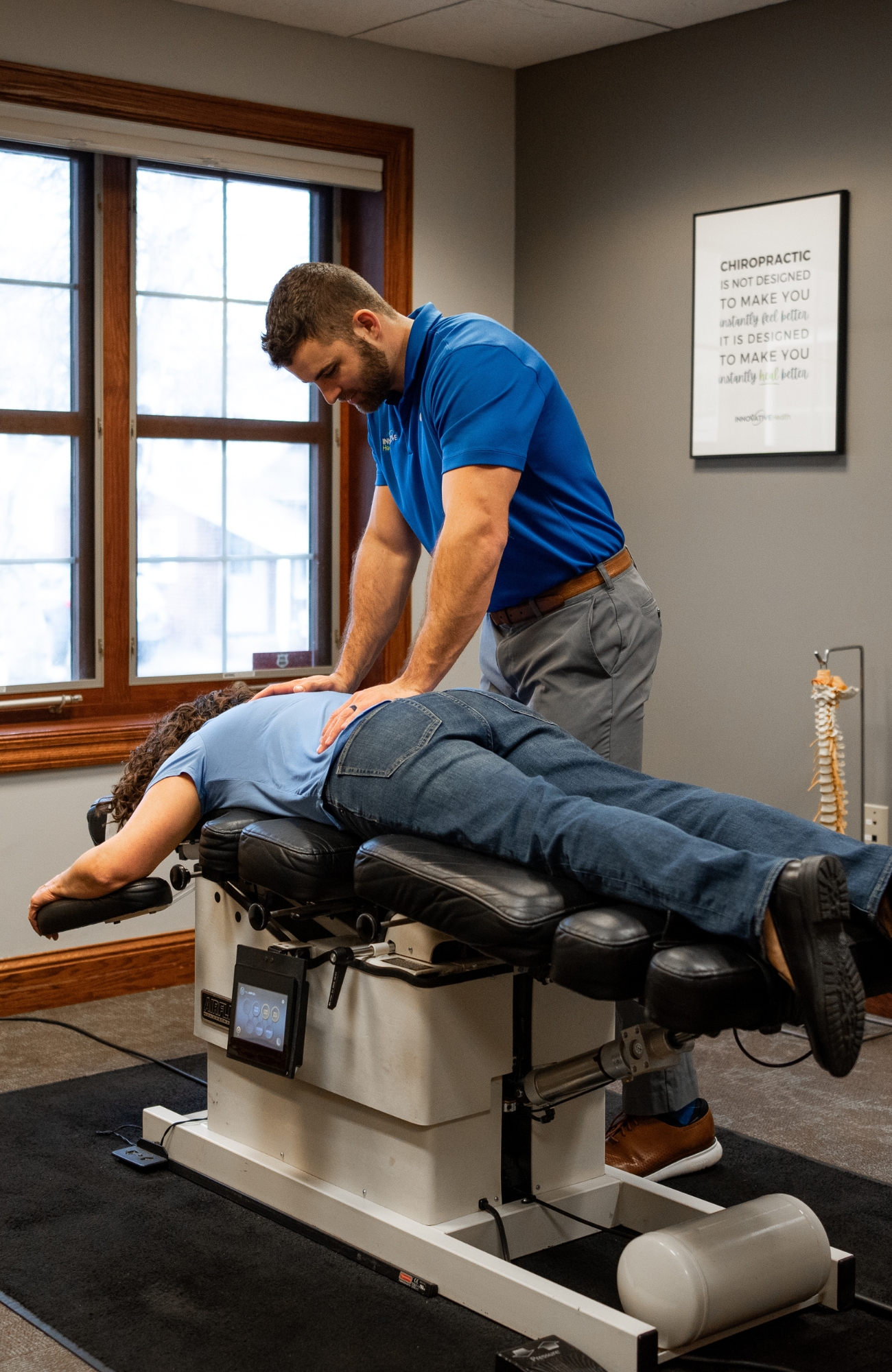 Hip adjustment and chiropractic care at Innovative Health Chiropractor performing hip adjustment on a patient lying face down on a treatment table